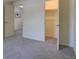 Neutral bedroom with carpet, a nearby closet, and a view of the hall at 11867 Elk Head Range Rd, Littleton, CO 80127
