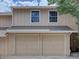 Exterior view of a home featuring a two-car garage with light colored doors at 11867 Elk Head Range Rd, Littleton, CO 80127