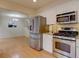 Modern kitchen with stainless steel appliances, granite countertops, and a view of the living area at 11867 Elk Head Range Rd, Littleton, CO 80127