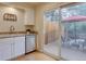 Bright kitchen with granite countertops, stainless steel dishwasher, and sliding door to patio at 11867 Elk Head Range Rd, Littleton, CO 80127