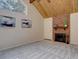 Bright living room featuring vaulted ceiling, cozy fireplace and neutral carpeting at 11867 Elk Head Range Rd, Littleton, CO 80127