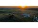 Expansive aerial view of horse property with riding arena at sunset at 27115 County Road 13, Elizabeth, CO 80107