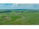 Expansive aerial view of horse property and large, green open range at 27115 County Road 13, Elizabeth, CO 80107
