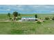 Aerial view of a two-story home with a walk-out, wraparound balcony and green roof at 27115 County Road 13, Elizabeth, CO 80107