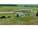 Riding arena and stables compliment the home in this aerial view of horse property at 27115 County Road 13, Elizabeth, CO 80107