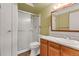 Bathroom with a walk-in shower and wood vanity at 13626 E Bates Ave # 207, Aurora, CO 80014