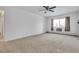 Large bedroom with window, ceiling fan, and carpet flooring at 13626 E Bates Ave # 207, Aurora, CO 80014