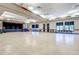 Large community room with hardwood floors and stage at 13626 E Bates Ave # 207, Aurora, CO 80014