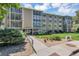 Attractive condo building with a manicured lawn and professional landscaping at 13626 E Bates Ave # 207, Aurora, CO 80014