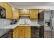 Bright kitchen features granite countertops and black appliances at 13626 E Bates Ave # 207, Aurora, CO 80014