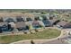 Aerial view of the home's backyard with a white fence, landscaping, and surrounding neighborhood at 1005 Alpine Aven St, Henderson, CO 80640