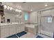 Luxurious bathroom with double vanities, separate tub, and tiled shower at 1005 Alpine Aven St, Henderson, CO 80640