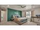 Cozy bedroom featuring a green accent wall and natural light at 1005 Alpine Aven St, Henderson, CO 80640