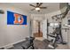 Bedroom with a ceiling fan, gym equipment, and neutral color scheme at 1005 Alpine Aven St, Henderson, CO 80640