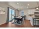 Bright dining room with sliding glass doors to outside, with access to kitchen area at 1005 Alpine Aven St, Henderson, CO 80640