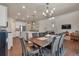 Stylish kitchen with stainless steel appliances, a large island, and open to dining area at 1005 Alpine Aven St, Henderson, CO 80640