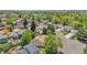 Elevated view of a home in a quiet neighborhood, surrounded by mature trees and shrubs at 8848 Prickly Pear Cir, Parker, CO 80134