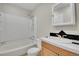 Functional bathroom showcasing a combined tub and shower and a vanity with a black and white tiled backsplash at 8848 Prickly Pear Cir, Parker, CO 80134