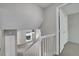 Hallway with carpeted stairs, neutral colored walls, and a ceiling fan in the adjacent room at 8848 Prickly Pear Cir, Parker, CO 80134