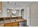 Bright kitchen area with stainless steel appliances and countertops, leading to the adjacent dining space with natural light at 8848 Prickly Pear Cir, Parker, CO 80134