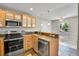 Open kitchen area with modern appliances and countertops, seamlessly connecting to the adjacent dining space with natural light at 8848 Prickly Pear Cir, Parker, CO 80134