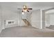 Large living room featuring neutral paint, a ceiling fan, and staircase access to the upper level at 8848 Prickly Pear Cir, Parker, CO 80134