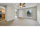 Spacious living room showcasing neutral paint, a ceiling fan, and access to the kitchen at 8848 Prickly Pear Cir, Parker, CO 80134