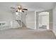 Spacious living room showcasing neutral paint, a ceiling fan, and archway access to the dining area at 8848 Prickly Pear Cir, Parker, CO 80134