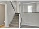 Staircase leading to the next level, featuring carpeted steps and railing, creating a smooth transition between floors at 8848 Prickly Pear Cir, Parker, CO 80134