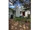 Overgrown front yard featuring a white house with a red door and discarded furniture at 3150 W 134Th Ave, Broomfield, CO 80020
