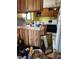 Image of kitchen with outdated appliances, yellow walls, and clutter on the floor at 3150 W 134Th Ave, Broomfield, CO 80020