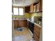 Image of kitchen with outdated appliances, yellow walls, and cluttered countertops at 3150 W 134Th Ave, Broomfield, CO 80020
