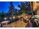 Outdoor deck featuring comfortable seating, string lights, and views of lush greenery at 9658 Coronado Ct, Parker, CO 80134