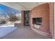 Covered brick patio featuring a fireplace and outdoor living space at 3905 S Jersey St, Denver, CO 80237