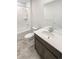 Bright bathroom featuring a vanity with marble countertop, a shower with white tiling, and neutral walls at 762 Penn Rd, Elizabeth, CO 80107