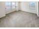 Bright bedroom with neutral carpet and lots of natural light from two windows at 762 Penn Rd, Elizabeth, CO 80107