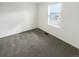 Empty bedroom featuring neutral carpet, a large window, and fresh paint, ready for personalization at 762 Penn Rd, Elizabeth, CO 80107