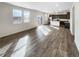 Spacious living room flows into the kitchen featuring new light-colored laminate flooring at 762 Penn Rd, Elizabeth, CO 80107