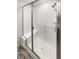 Modern shower with glass enclosure, tiled walls, and built-in seat at 762 Penn Rd, Elizabeth, CO 80107