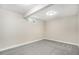 Finished basement room with neutral carpeting and window well at 6714 Depew St, Arvada, CO 80003