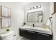 Modern bathroom with floating vanity, updated fixtures, and a frameless glass shower at 6714 Depew St, Arvada, CO 80003