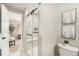 Updated bathroom with walk-in shower and view into bedroom at 6714 Depew St, Arvada, CO 80003