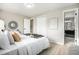 Main bedroom with a plush bed and access to the ensuite bathroom at 6714 Depew St, Arvada, CO 80003