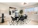 Modern dining room with an abstract painting and hardwood floors at 6714 Depew St, Arvada, CO 80003