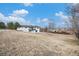 Back of the house showing a large backyard and patio at 6714 Depew St, Arvada, CO 80003