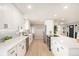 Modern kitchen with white cabinets and quartz countertops at 6714 Depew St, Arvada, CO 80003