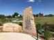 Britton park entrance with stone marker and basketball court in background at 6714 Depew St, Arvada, CO 80003