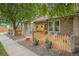 Charming brick home featuring a well-kept front yard, fence and inviting front porch at 9193 W 7Th Ave, Lakewood, CO 80215