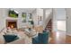 Bright living room featuring a fireplace, hardwood floors, and staircase to the upper level at 9193 W 7Th Ave, Lakewood, CO 80215