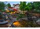 Gorgeous backyard waterfall feature with professional landscaping, hardscaping, and outdoor seating at 254 Lead Queen Dr, Castle Rock, CO 80108